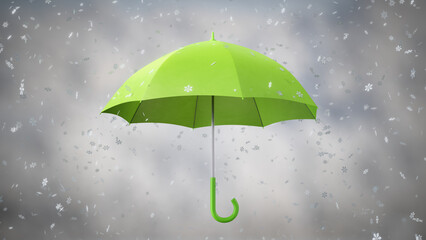 Winter snowflakes falling on the green rotating Umbrella