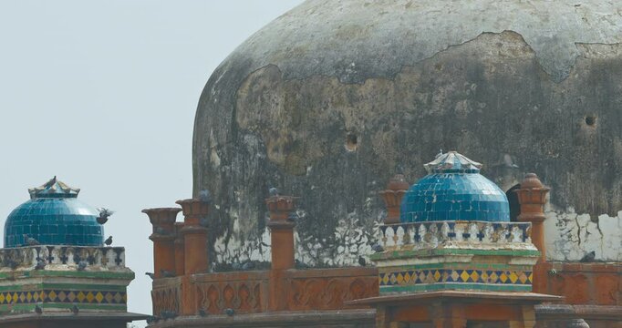 New Delhi, Delhi, India. Doves birds flying above Babur's Tomb near The Humayun's tomb. Famous place is Tomb of Mughal emperor, Mirza Nasir al-Din Muhammad commonly known as Humayun situated in Delhi
