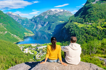 Naklejka premium Norwegian Fjord Views From a Mountaintop, couple at Geiranger Fjord Norway