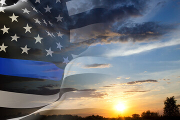 Thin Blue Line. Black Flag of USA with Police Blue Line against the sunset. National Law Enforcement Appreciation Day concept