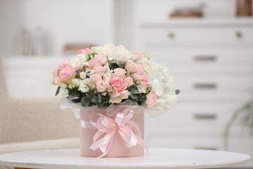 Beautiful bouquet in box on table at home