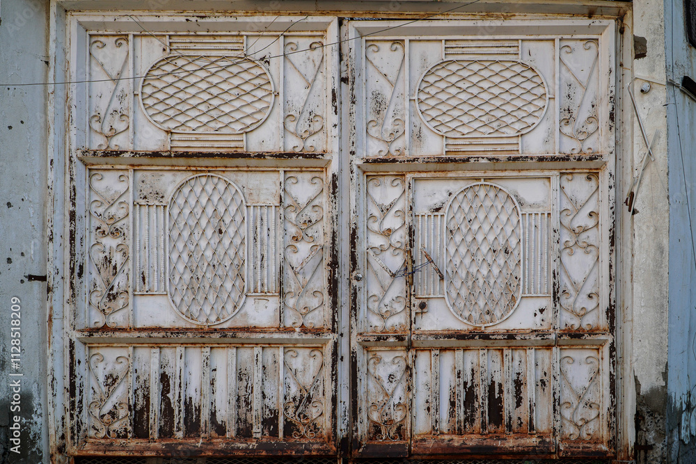 Aufkleber close-up of an aged, ornate metal gate showing rust and weathering. the intricate design and texture