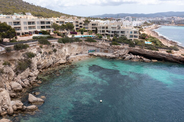 Aerial drone photo of the town of Sant Antoni de Portmany on the west coast of Ibiza, one of Spains Balearic Islands, showing hotels, apartments and businesses on the village on a sunny summers day