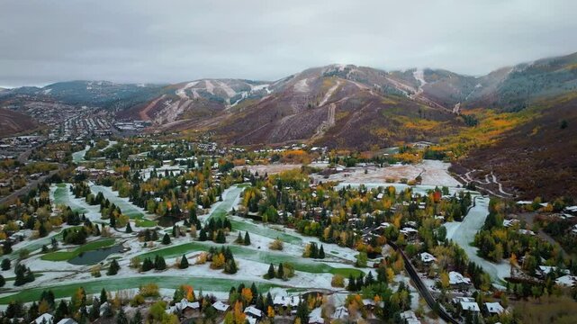 Park City base area Canyons Village Vail Olympic ski Resort Utah USA aerial drone golf course autumn winter fall autumn Aspen Tree colors first snow cloudy snowing misty cold grey circle left motion