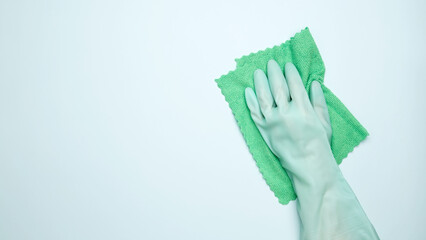 House cleaning. Womans hand in rubber glove holds cloths
