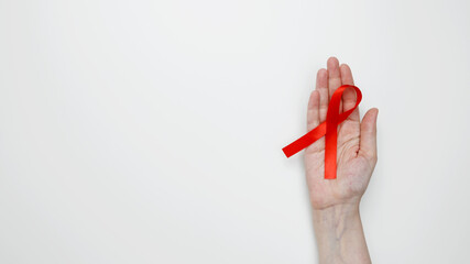 World AIDS Day. Woman holding red AIDS awareness ribbon