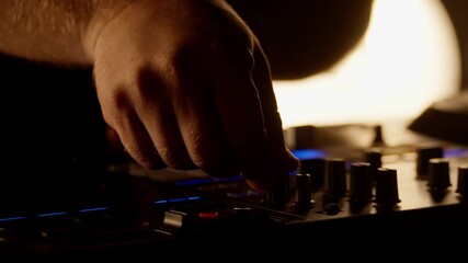Close-up of a dj's hands manipulating knobs and buttons on a mixing console, creating a captivating visual representation of music production - Powered by Adobe