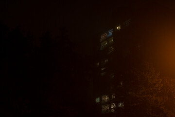 A blurry picture of a building that is beautifully illuminated at nighttime, showcasing its...