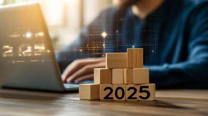 2025 New Year Celebration - Wooden Number Blocks, a businessman working with a laptop and building block stacks up to the number "2025" on a digital screen background for the new year 