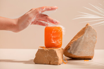 Lathering Orange Soap Bar on Rocks Spa Wellness Clean