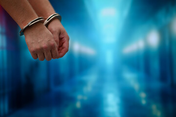 Handcuffed wrists of a criminal arrested for committing a crime, law enforcement concept