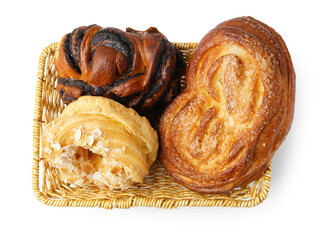 Different delicious pastries in basket isolated on white, top view