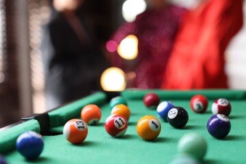 Many colorful billiard balls on green table indoors, closeup. Space for text