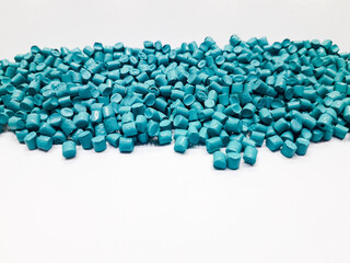 Bright blue masterbatch granules on white background, polymer carrier of color pigment in plastic industry. Perfect for plastic company catalog design.
