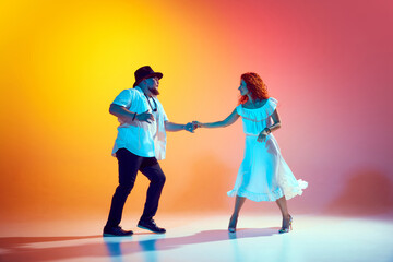 Latin dancers perfect their salsa routine, focusing on each step's precision and fluidity in...