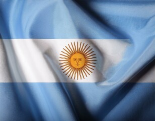 closeup photo of the Argentine flag, blue and white, with the yellow sun in the center, waving