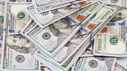 heap of one hundred dollar bills as background, close-up