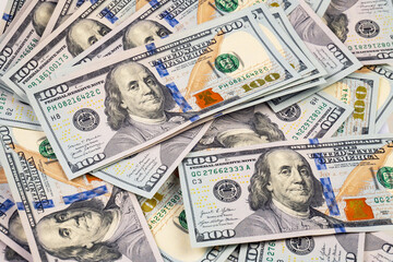 heap of one hundred dollar bills as background, close-up