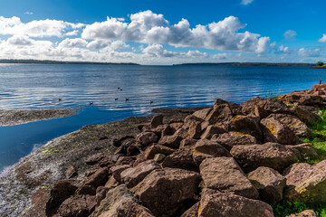 A view over rocks out across the bay on the shoreline at Victoria Park in Charlottetown, Prince...