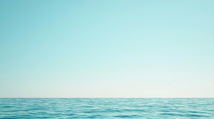 Obraz premium A serene ocean view with a clear blue sky above and calm waters below.