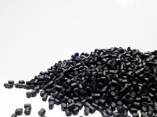 Black masterbatch granules on white background, polymer carrier of color pigment in plastic...