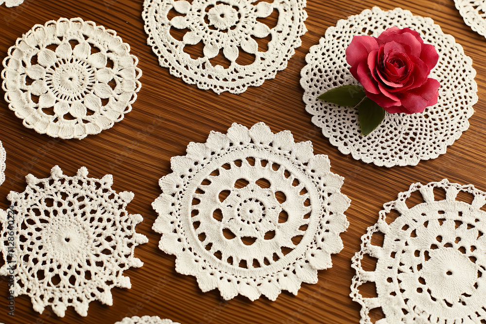 Poster a collection of vintage doilies in varying patterns arranged on a wooden surface