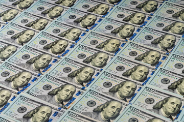 Background of many american one hundred dollar banknotes. A pile of new one hundred US dollars. Cash of hundred dollar bills, closeup