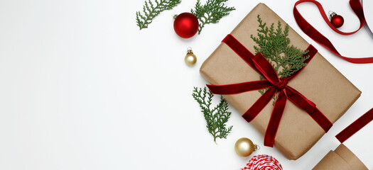 Cozy holiday atmosphere, Christmas gifts being wrapped with festive decorations, ribbons, paper