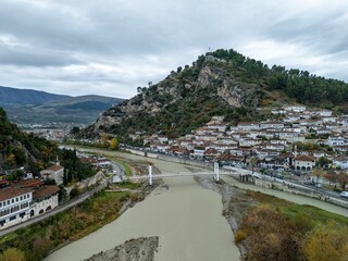 Aerial view of Berat, Albania, showcasing historical architecture and lush hills by the Osum River