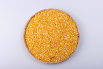Grits of corn on a wooden plate
