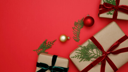 Christmas ornaments, gifts wrapped in craft paper, thuja branches arranged