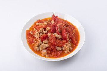 Roast pork with tomatoes on a plate