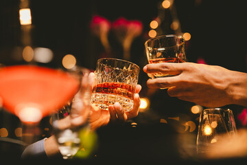 Alcohol and people hands for a night party to celebrate birthday or fun. Group of friends and drinking on the dance floor with shots.