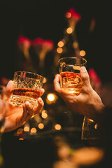 Alcohol and people hands for a night party to celebrate birthday or fun. Group of friends and drinking on the dance floor with shots.