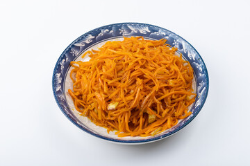 Fried shredded carrots on a plate