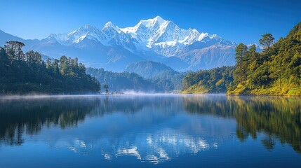 Obraz premium Majestic snow-capped mountains reflect in serene lake at sunrise