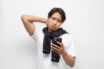 Sad and Pensive Young Asian Man Holding Smartphone with a Pouting Expression