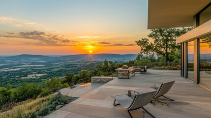 Fototapeta premium Sunset view from a modern patio overlooking a valley..