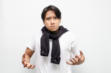 Angry Young Asian Man Shouting and Clenching His Fist in Rage