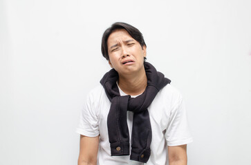 Young Asian Man Crying with a Sad Expression, Showing Deep Emotions