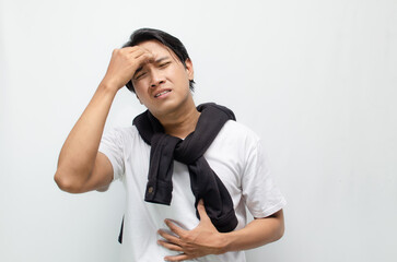Young Asian Man Holding His Head in Pain, Experiencing Intense Dizziness