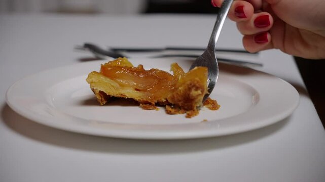 Woman pick up piece of delicious apple strudel in cafe