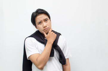 Young Asian Man Deep in Thought with a Pensive Expression