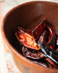 Preparing Mexican Mole Negro. Oaxaca chiles have to be cleaned, toasted on a comal over a flame and soaked in water before grinding with metate.