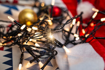 Vintage wire christmas candle lights with hot short circuit sparks  , soft focus close up, fire hazard concept