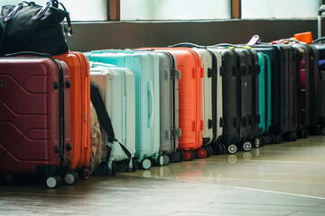 A vibrant collection of suitcases, ready for a thrilling travel experience. Various colors and sizes are lined up, awaiting the next exciting adventure. A Row of Colorful Suitcases Ready for Travel.