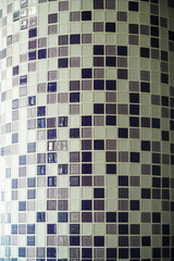 Close-up of a curved wall with a mosaic of purple and white tiles. The abstract pattern wall texture. Abstract Purple and White Mosaic Tile Wall Texture.