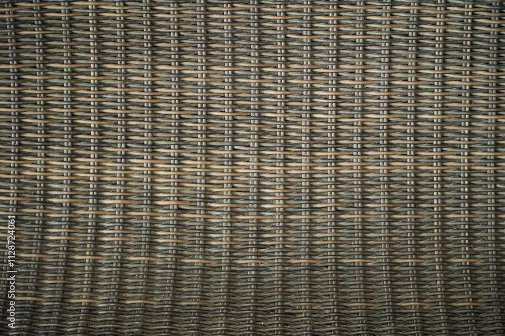 Poster close-up view of an intricately woven rattan or wicker texture. the image shows the detail and compl