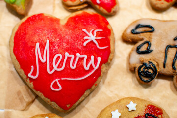 colorful heart-shaped gingerbread cookies with the words Merry, stars and a camper