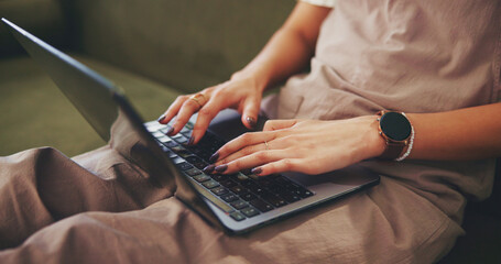 Hands, typing and laptop with woman on sofa for social media, reading blog and streaming service....